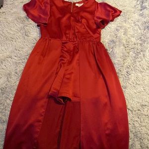 A red silk romper with a train.